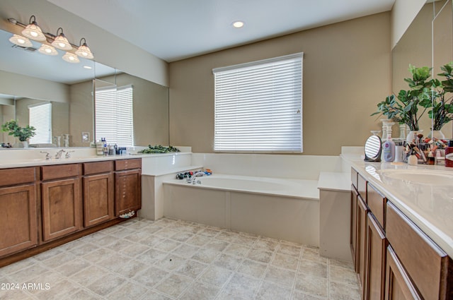 bathroom featuring vanity and a bath