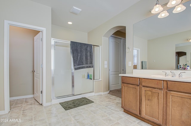 bathroom featuring vanity and an enclosed shower