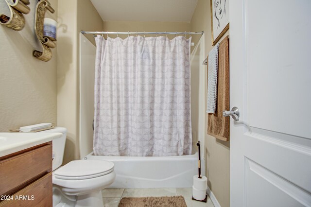 full bathroom with toilet, shower / tub combo, vanity, and tile patterned floors