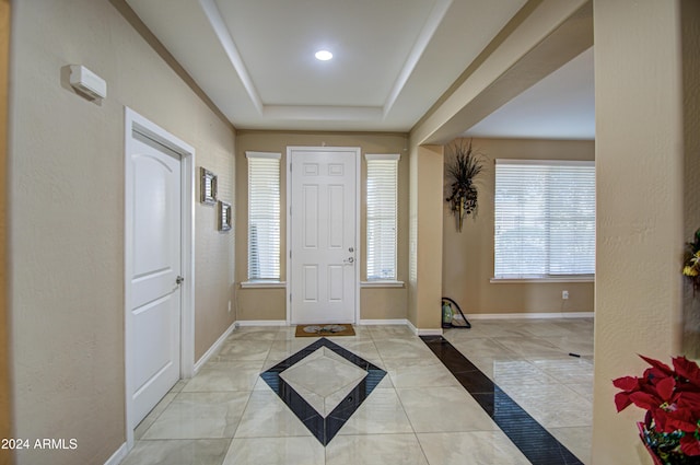 entryway with a raised ceiling