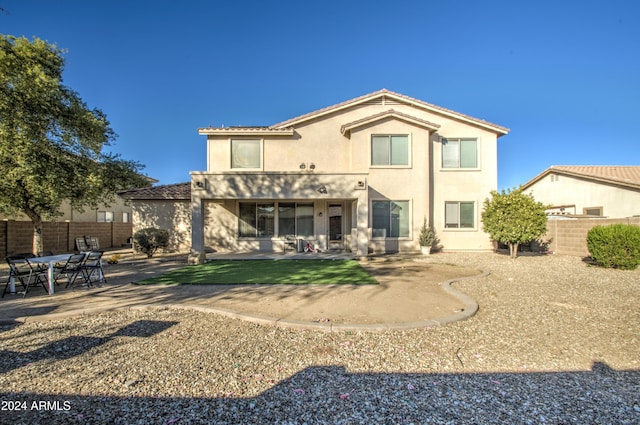 rear view of property featuring a patio