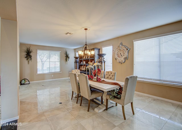 dining space with a notable chandelier