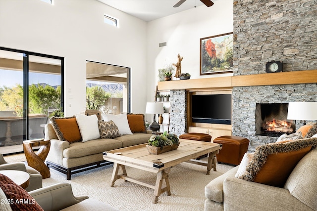 9894 E Miramonte Dr, Scottsdale, AZ 85262 - carpeted living room featuring ceiling fan, a fireplace, and a high ceiling