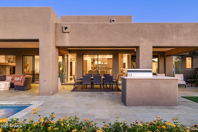 9894 E Miramonte Dr, Scottsdale, AZ 85262 - back of house with exterior kitchen, a patio area, an outdoor hangout area, and stucco siding