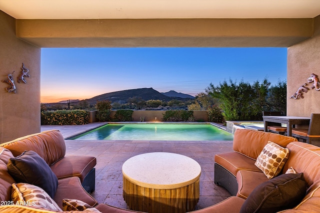 9894 E Miramonte Dr, Scottsdale, AZ 85262 - pool at dusk featuring a mountain view, a patio, and a fenced backyard
