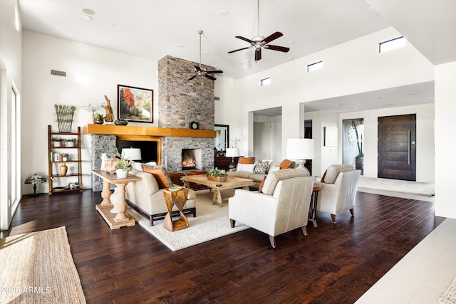 9894 E Miramonte Dr, Scottsdale, AZ 85262 - living area featuring a stone fireplace, a high ceiling, wood finished floors, and ceiling fan