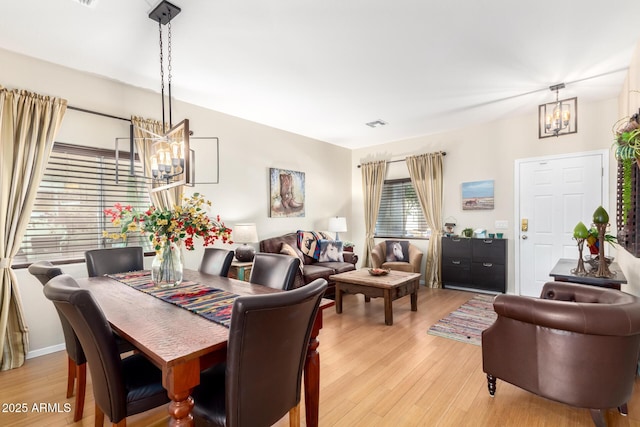 dining room featuring a chandelier and light wood-type flooring