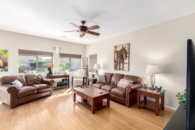 living room with ceiling fan and light wood-type flooring