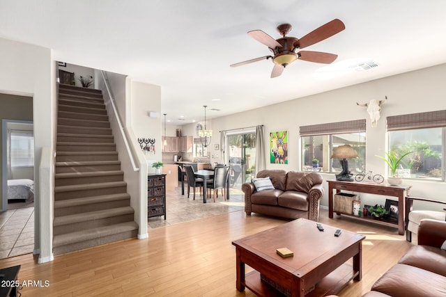 living room with ceiling fan and light hardwood / wood-style flooring