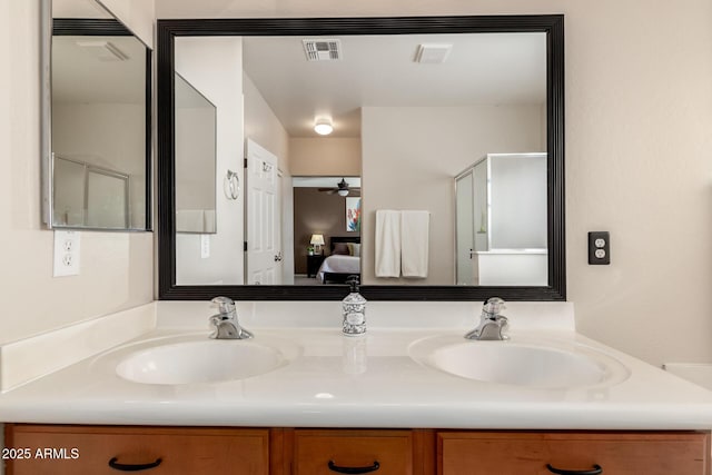 bathroom with vanity and a shower with door