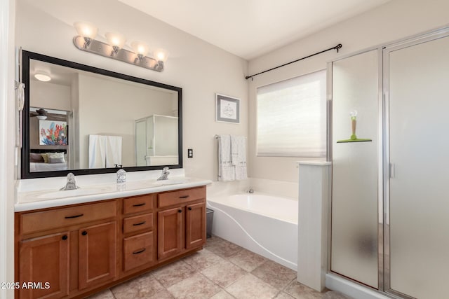 bathroom featuring tile patterned flooring, shower with separate bathtub, and vanity