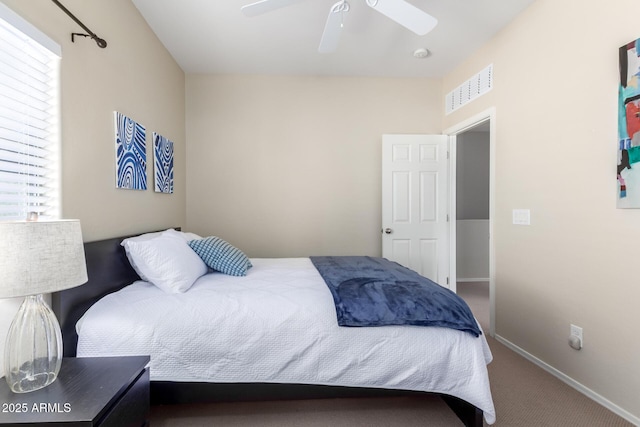 carpeted bedroom with multiple windows and ceiling fan