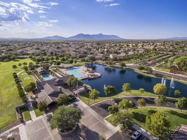 birds eye view of property with a water and mountain view