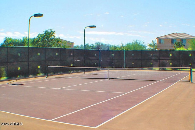 view of tennis court featuring basketball hoop