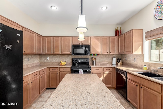 kitchen with pendant lighting, sink, tasteful backsplash, and black appliances