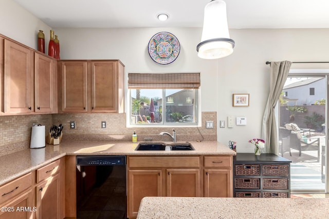 kitchen with pendant lighting, dishwasher, sink, and backsplash