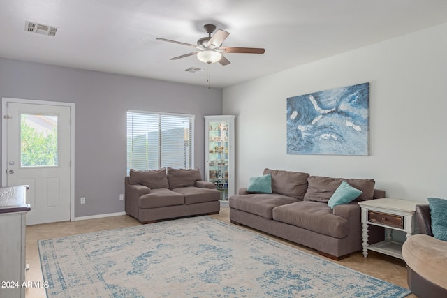 living room with tile patterned floors and ceiling fan