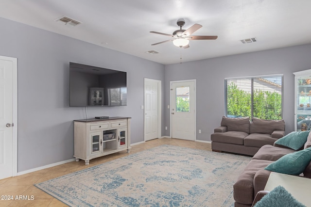 living room featuring light tile patterned floors and ceiling fan