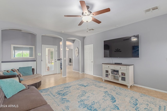 living room with light tile patterned floors and ceiling fan