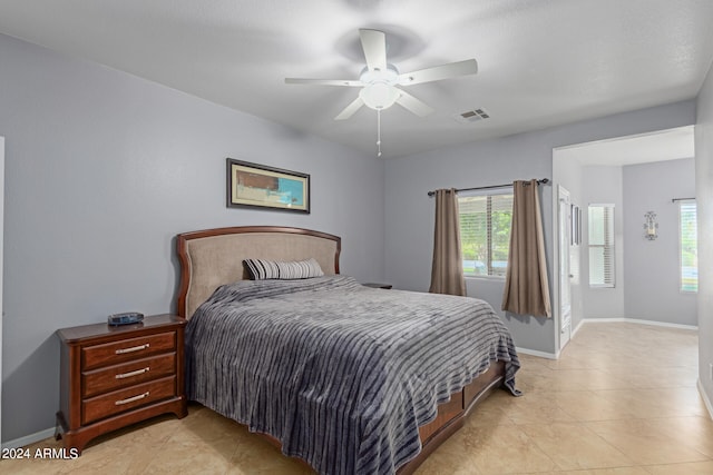 bedroom with ceiling fan and light tile patterned floors