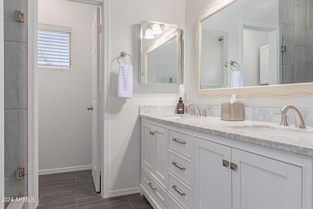 bathroom with vanity and a shower with door