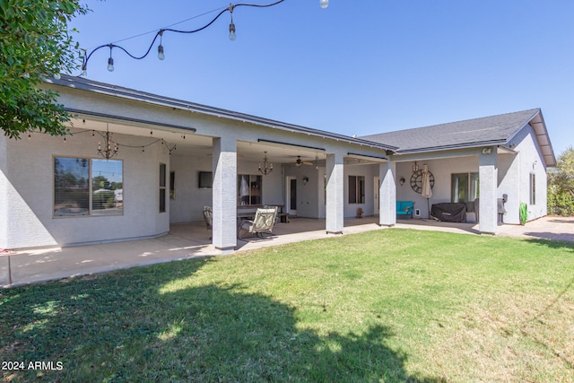 back of house featuring ceiling fan, a patio area, and a yard