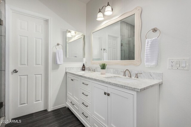 26719 S 195th St, Queen Creek, AZ 85142 - full bathroom with tiled shower, double vanity, a sink, and wood finished floors