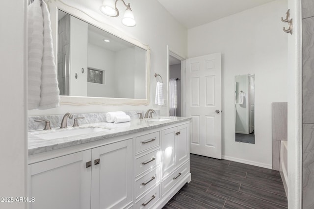 26719 S 195th St, Queen Creek, AZ 85142 - full bath with a sink, baseboards, double vanity, and wood finish floors