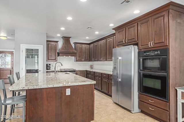 kitchen featuring sink, a kitchen breakfast bar, stainless steel refrigerator with ice dispenser, black double oven, and custom range hood