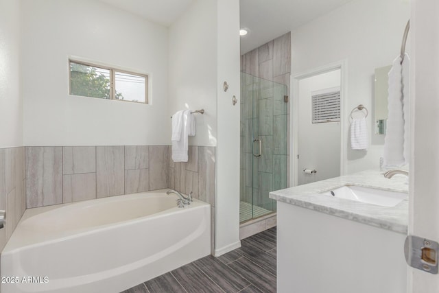 bathroom with vanity and independent shower and bath