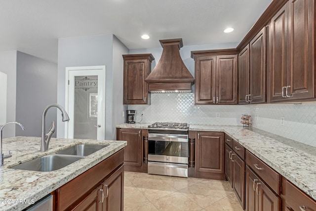 26719 S 195th St, Queen Creek, AZ 85142 - kitchen with custom exhaust hood, gas range, light stone counters, and a sink