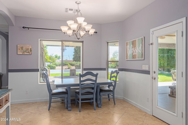 dining room featuring light tile patterned floors and a chandelier