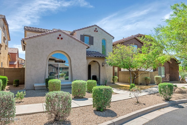 3932 E Melinda Dr, Phoenix, AZ 85050 - mediterranean / spanish home featuring stucco siding, a tiled roof, and fence