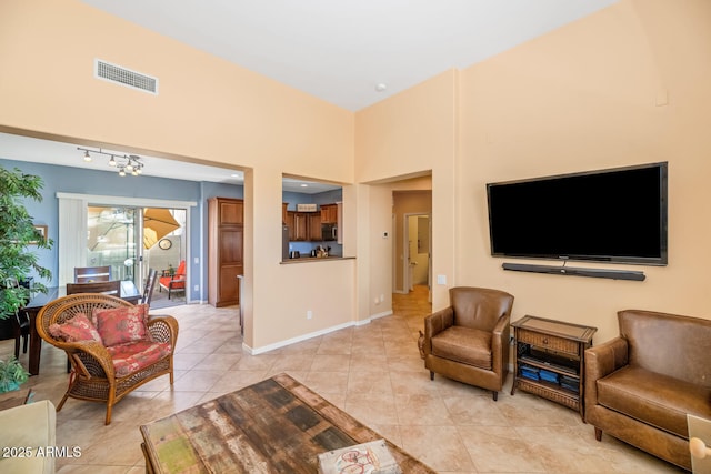3932 E Melinda Dr, Phoenix, AZ 85050 - living area featuring light tile patterned floors, visible vents, a towering ceiling, and baseboards