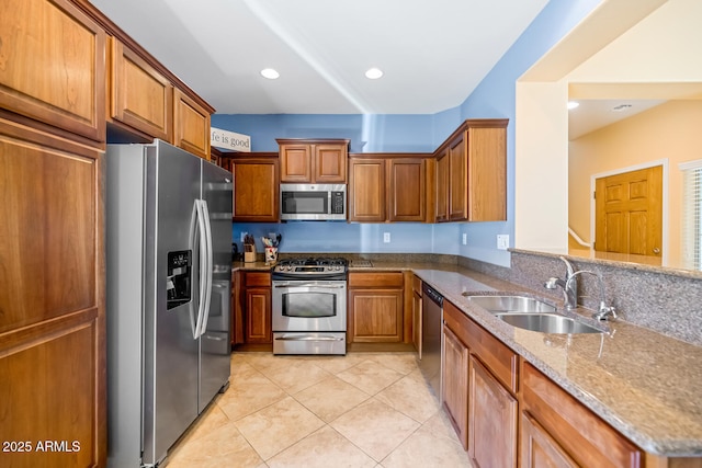 3932 E Melinda Dr, Phoenix, AZ 85050 - kitchen with light tile patterned floors, stainless steel appliances, brown cabinets, and a sink