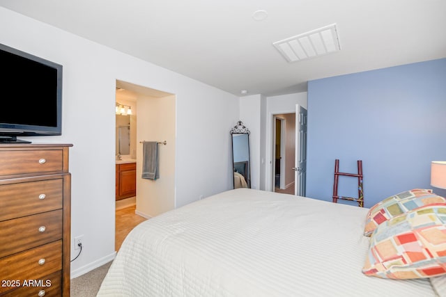 3932 E Melinda Dr, Phoenix, AZ 85050 - bedroom with ensuite bathroom, visible vents, light colored carpet, and baseboards