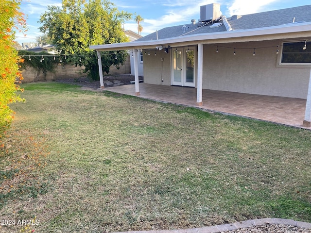 view of yard featuring central air condition unit and a patio area