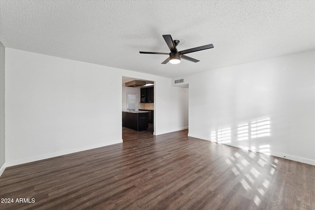 8420 E Hubbell St, Scottsdale, AZ 85257 - unfurnished living room featuring dark wood-style flooring, a ceiling fan, a textured ceiling, and baseboards