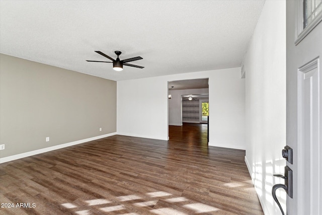 unfurnished room with ceiling fan, dark hardwood / wood-style flooring, and a textured ceiling