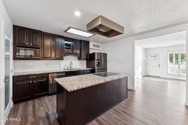 8420 E Hubbell St, Scottsdale, AZ 85257 - kitchen with appliances with stainless steel finishes, dark wood-style floors, dark brown cabinets, decorative backsplash, and a sink