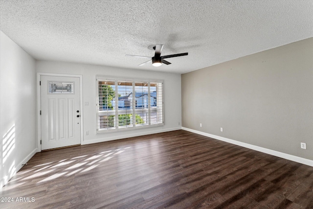 interior space with ceiling fan, dark hardwood / wood-style flooring, and a textured ceiling