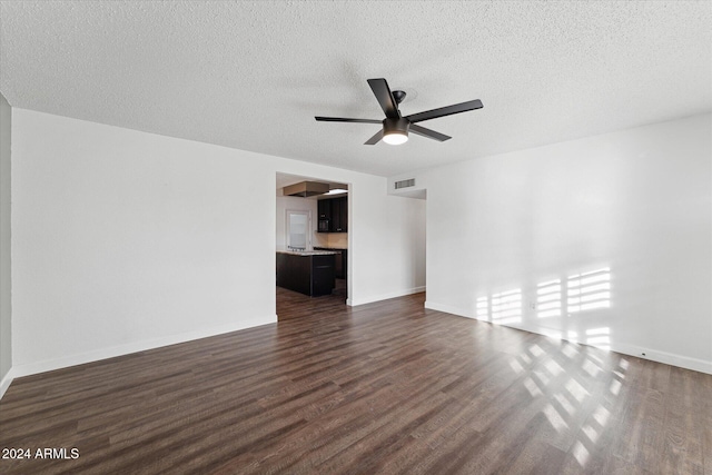 unfurnished room with ceiling fan, dark hardwood / wood-style flooring, and a textured ceiling