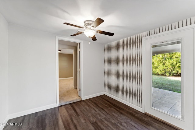 unfurnished room with dark hardwood / wood-style floors and ceiling fan