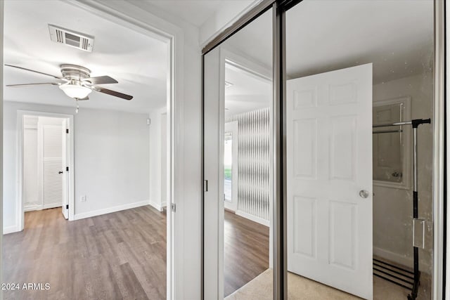 corridor with light hardwood / wood-style floors