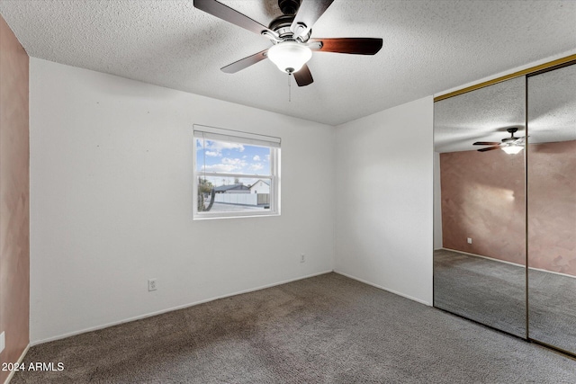 unfurnished bedroom with carpet flooring, ceiling fan, a closet, and a textured ceiling