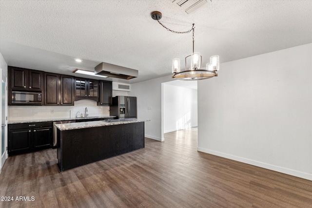 8420 E Hubbell St, Scottsdale, AZ 85257 - kitchen with black microwave, stainless steel fridge with ice dispenser, a sink, a center island, and a textured ceiling