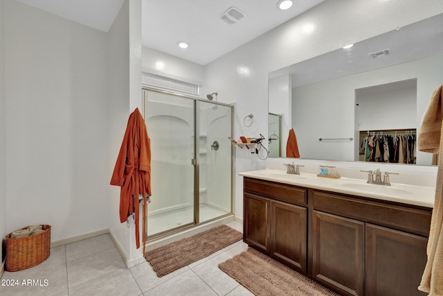 bathroom with vanity, a shower with shower door, and tile patterned flooring