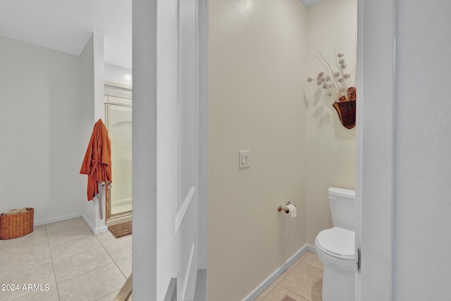 bathroom with toilet and tile patterned floors