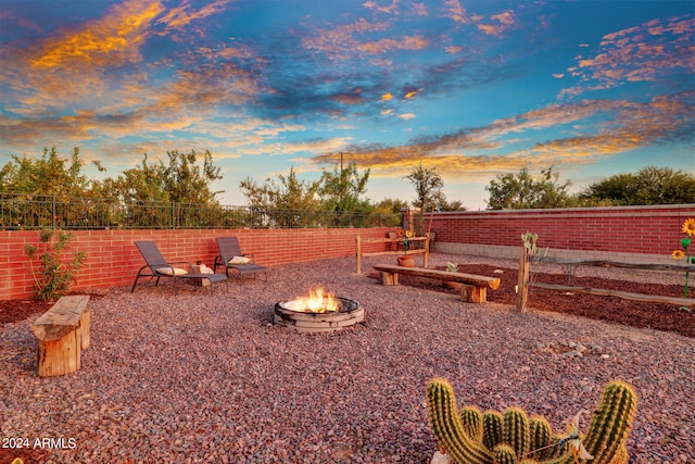 yard at dusk with a fire pit