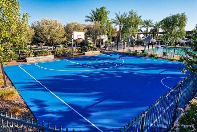 view of basketball court featuring a fenced in pool